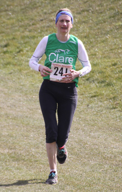 Clare Hazell approaching the finish in the sunshine at Compton in the 2013 Compton Downland 20 on Sunday, 4 November 2013.